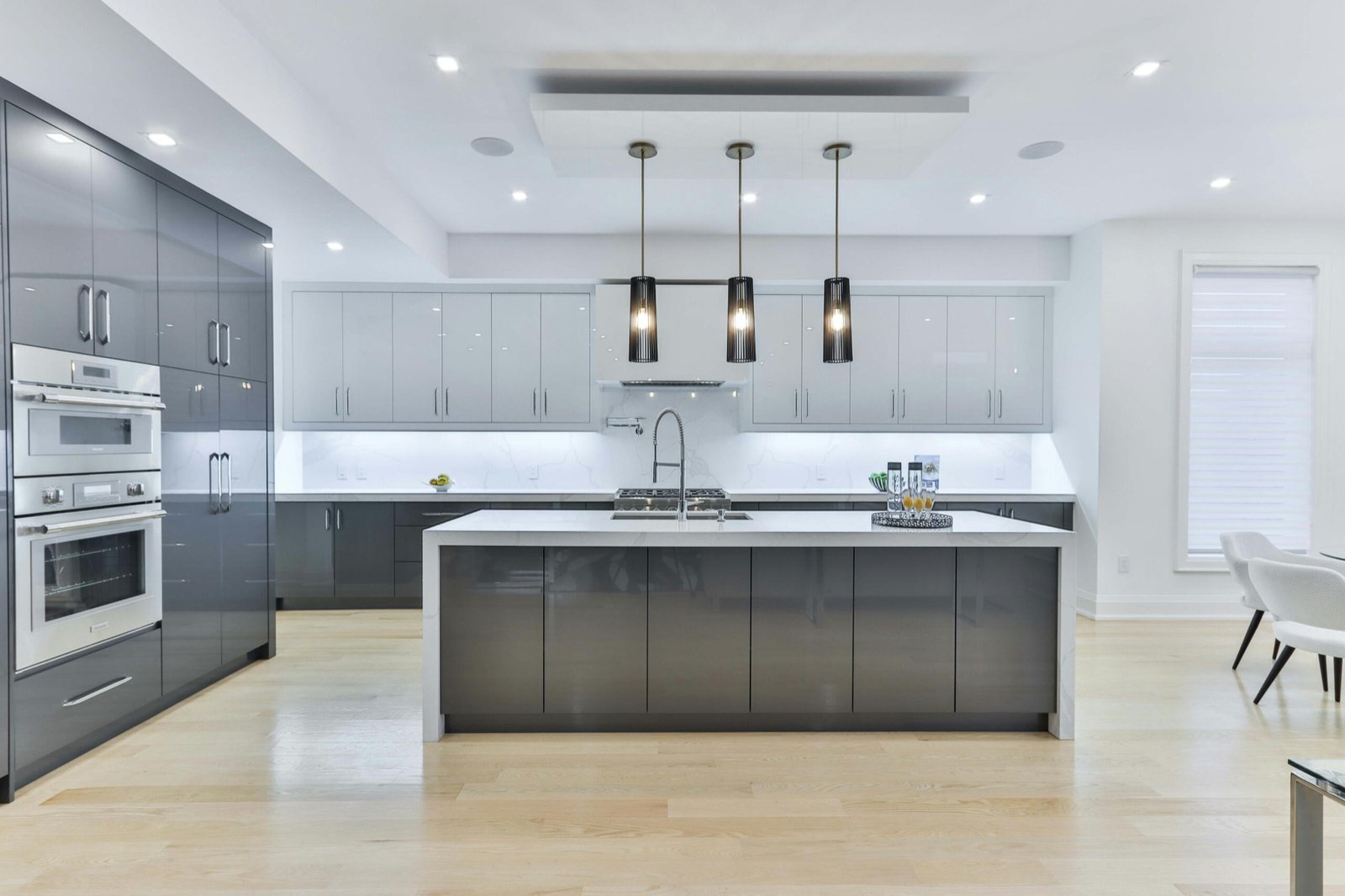 Modern gray and white kitchen renovation with custom cabinetry
